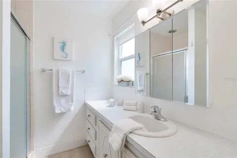 a bathroom with a sink vanity tub and shower