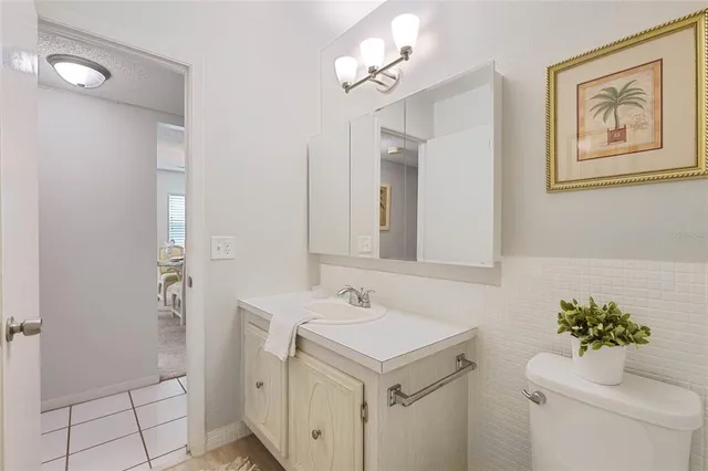 a bathroom with a sink vanity and a mirror