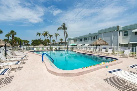 a view of a swimming pool with outdoor seating