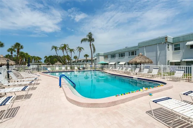 a view of a swimming pool with outdoor seating