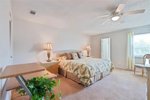 a spacious bedroom with two beds and a large window
