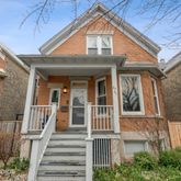 a view of a brick house with large windows
