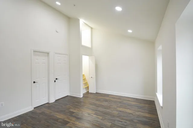 a view of an empty room with wooden floor
