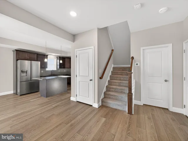 a view of kitchen with wooden floor and electronic appliances