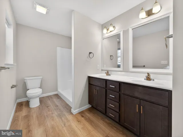 a bathroom with a sink vanity and a toilet