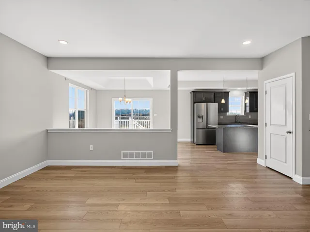 a view of kitchen with stainless steel appliances granite countertop a refrigerator and a sink