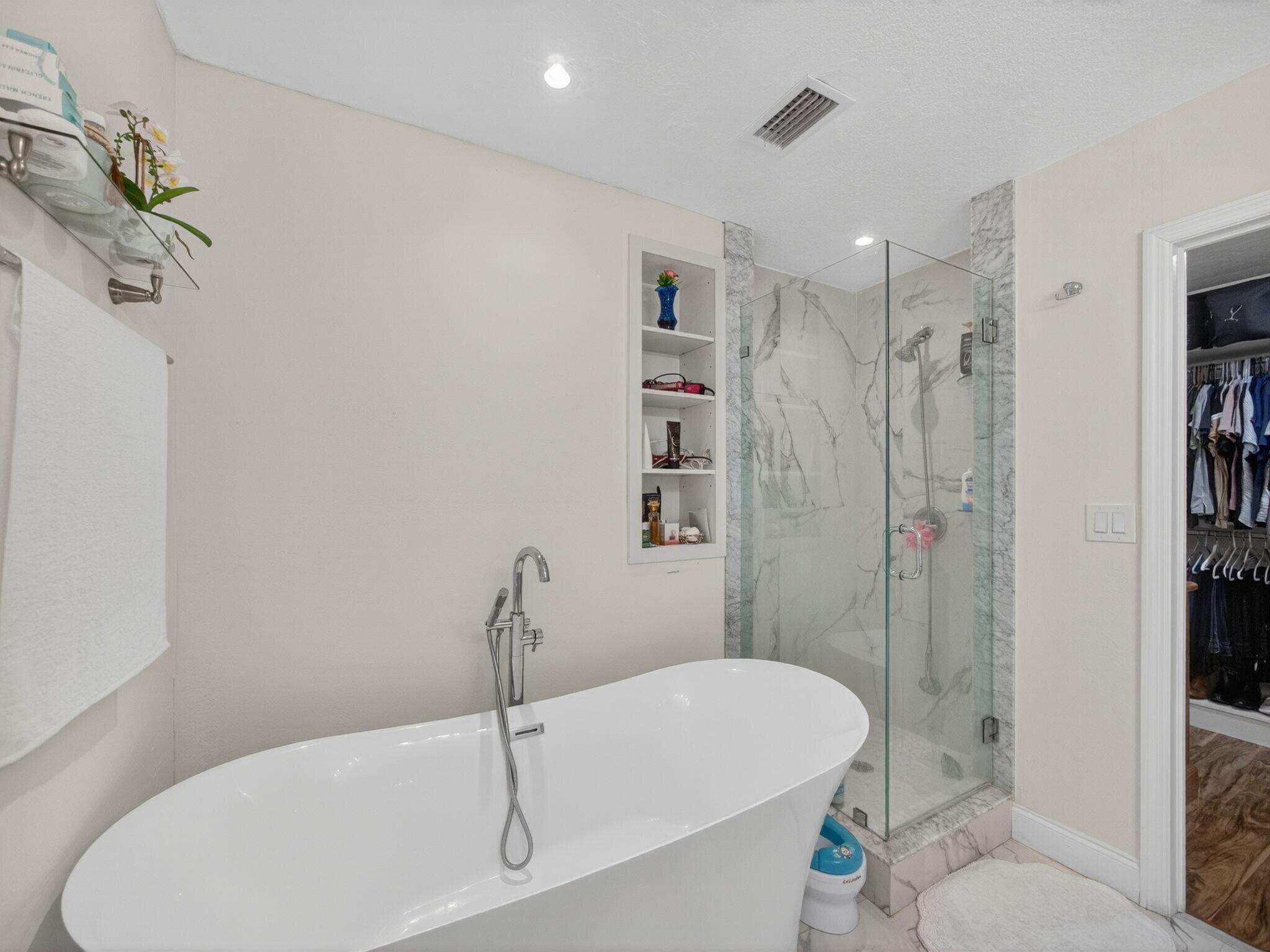 7026 Pine Tree Lane Lake Clarke Shores, FL 33406 - Photo 11 of 22 a bathroom with a sink a toilet and shower