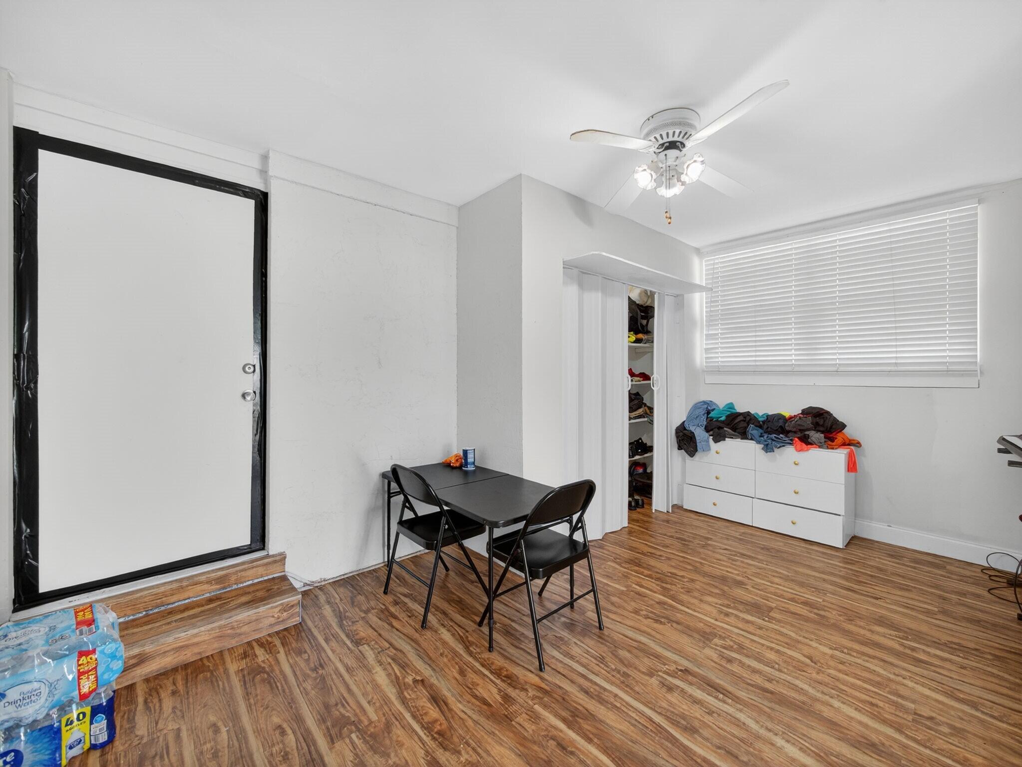 7026 Pine Tree Lane Lake Clarke Shores, FL 33406 - Photo 15 of 22 a living room with furniture and a wooden floor