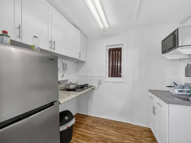 a bathroom with a sink mirror and shower