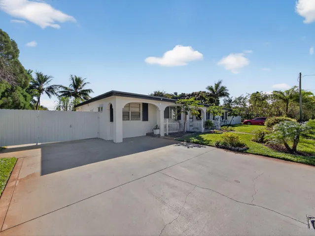 a view of a house with a yard and sitting area