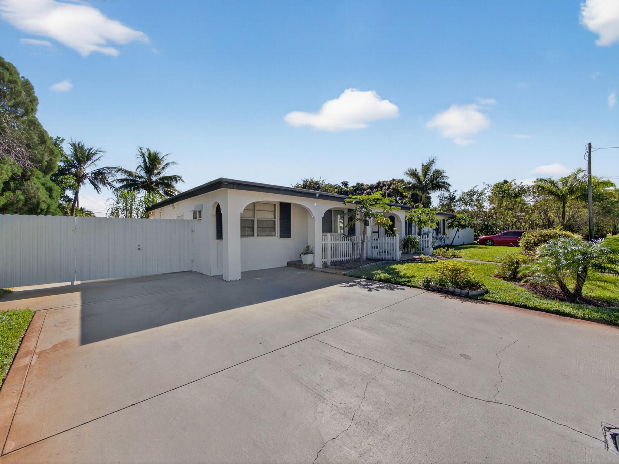 7026 Pine Tree Lane Lake Clarke Shores, FL 33406 - Photo 19 of 22 a view of a terrace with a yard