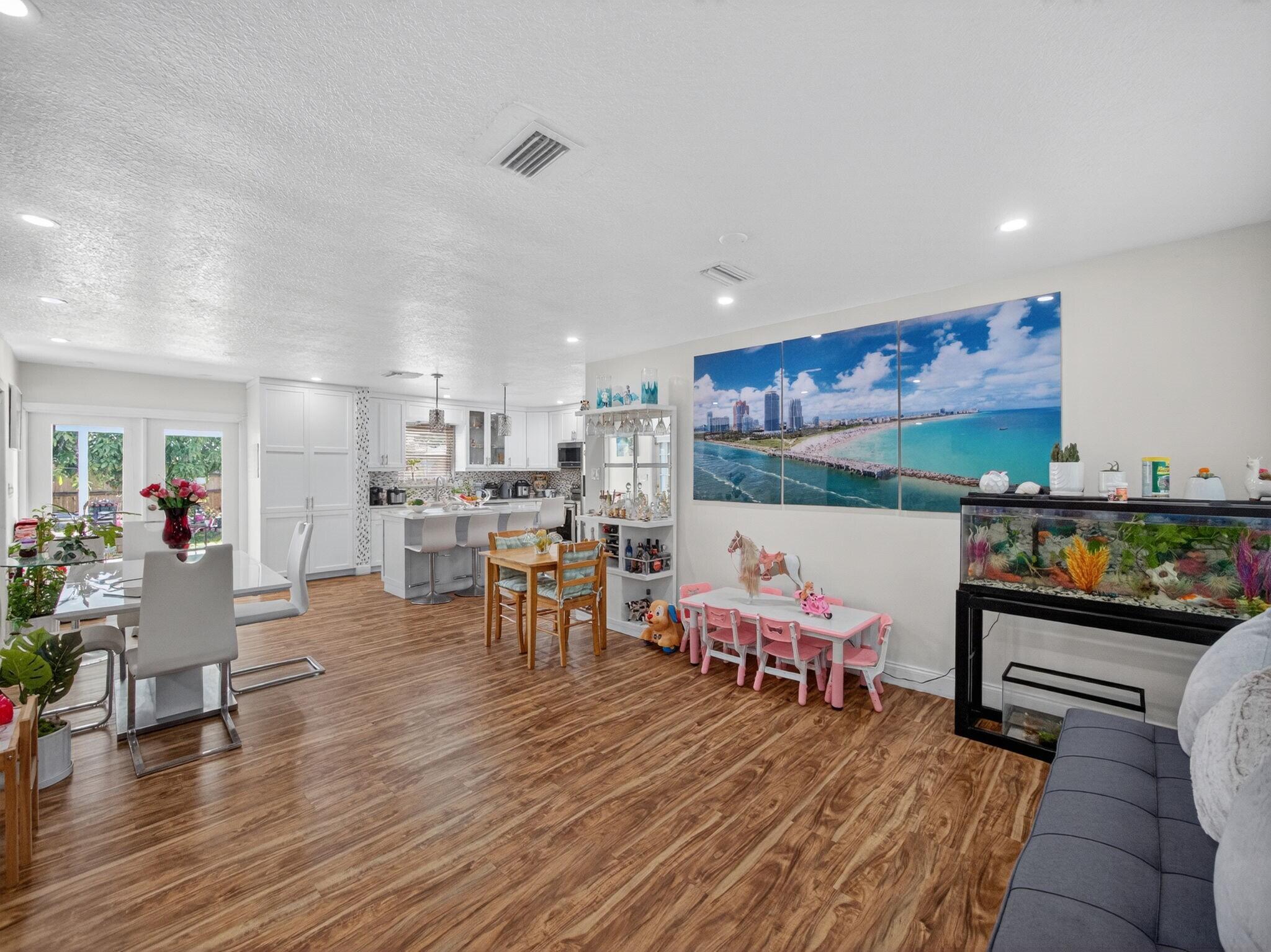 7026 Pine Tree Lane Lake Clarke Shores, FL 33406 - Photo 3 of 22 a living room with furniture and wooden floor