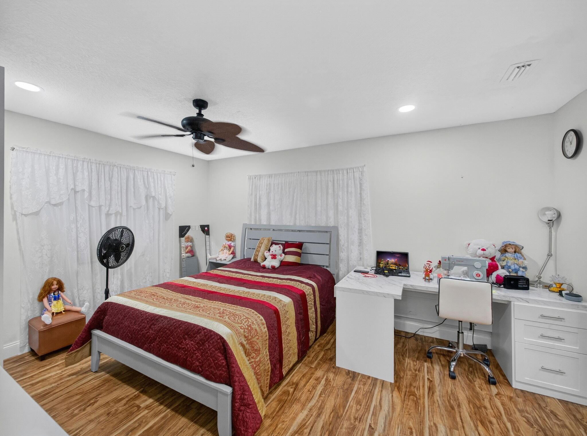 7026 Pine Tree Lane Lake Clarke Shores, FL 33406 - Photo 8 of 22 a bed room with a bed and a desk