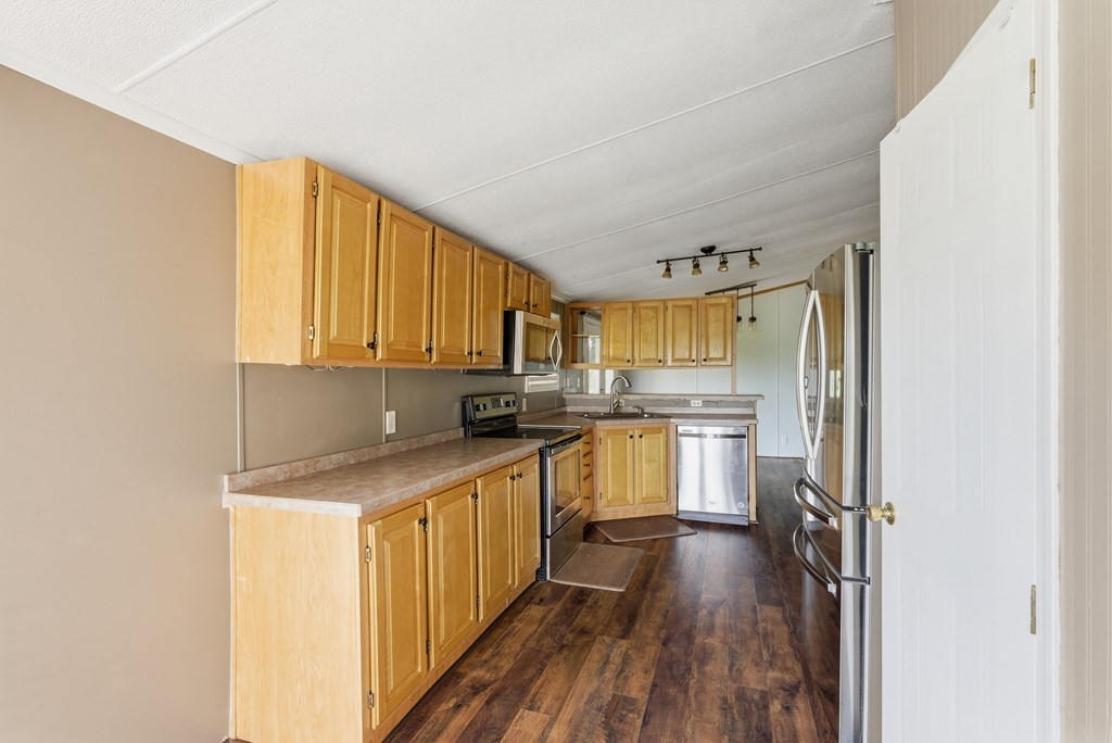 611 Farmer Road Walling, TN 38587 - Photo 13 of 27 a kitchen with a refrigerator a sink and wooden floor