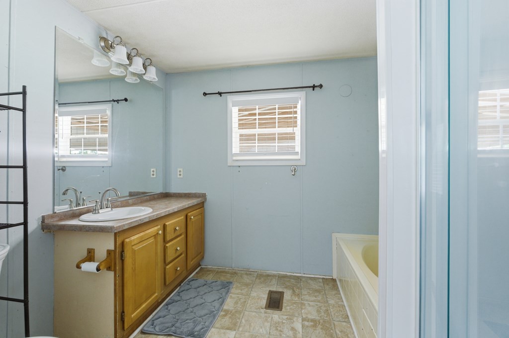 611 Farmer Road Walling, TN 38587 - Photo 18 of 27 a bathroom with a sink and a mirror