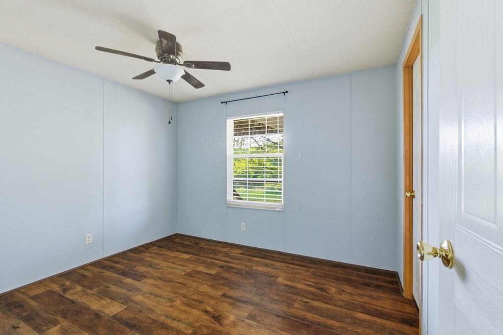 611 Farmer Road Walling, TN 38587 - Photo 20 of 27 a view of an empty room with wooden floor and a window
