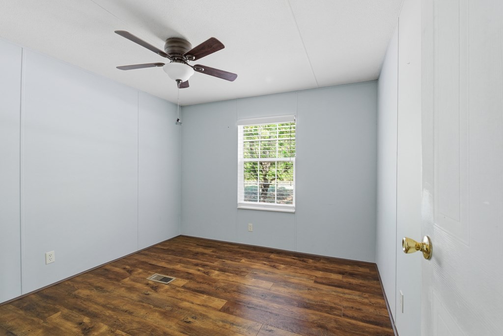 611 Farmer Road Walling, TN 38587 - Photo 23 of 27 a view of a livingroom with a ceiling fan and wooden floor