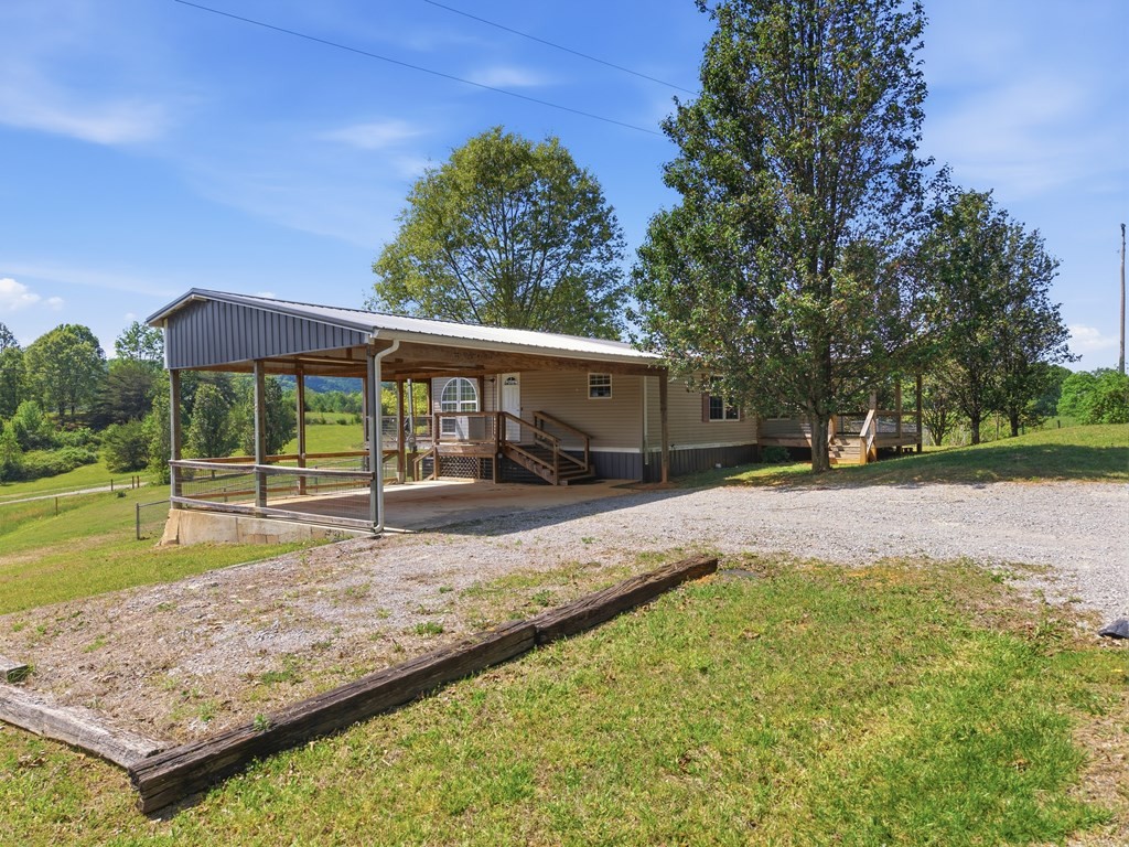 611 Farmer Road Walling, TN 38587 - Photo 3 of 27 a view of a house with backyard and sitting area