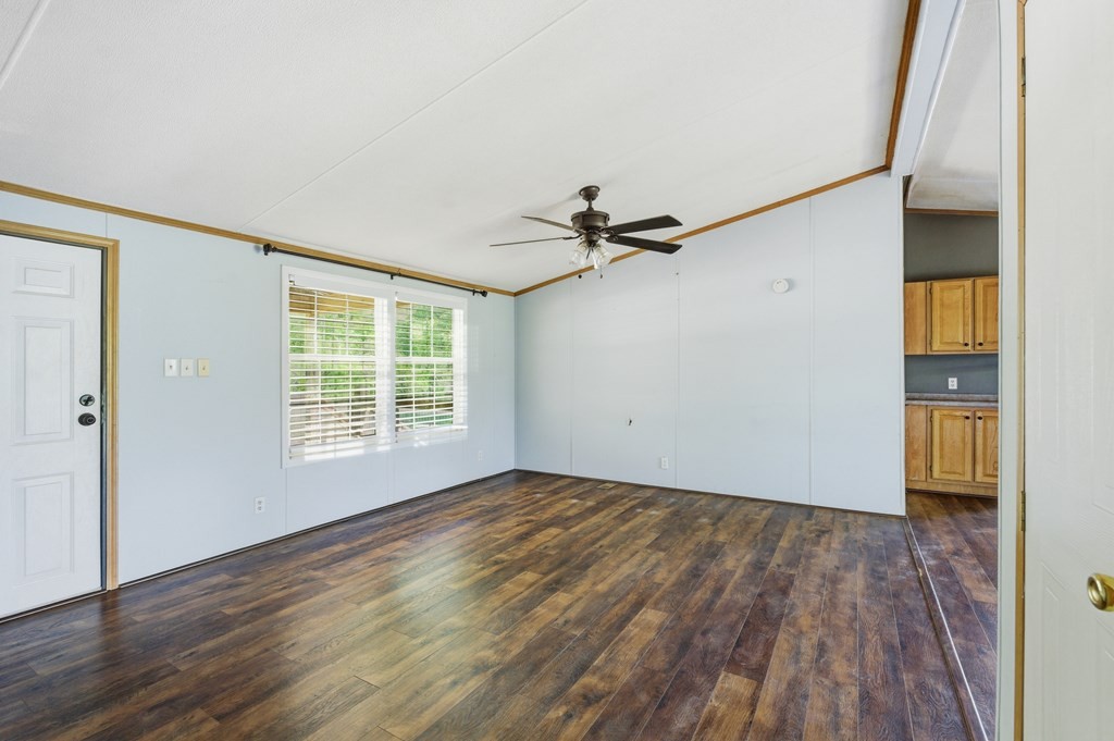 611 Farmer Road Walling, TN 38587 - Photo 7 of 27 a view of empty room with wooden floor and fan