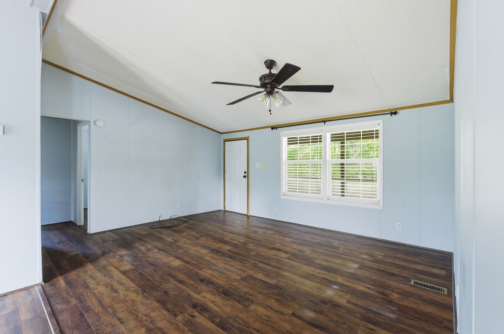611 Farmer Road Walling, TN 38587 - Photo 8 of 27 a view of an empty room with wooden floor and a window