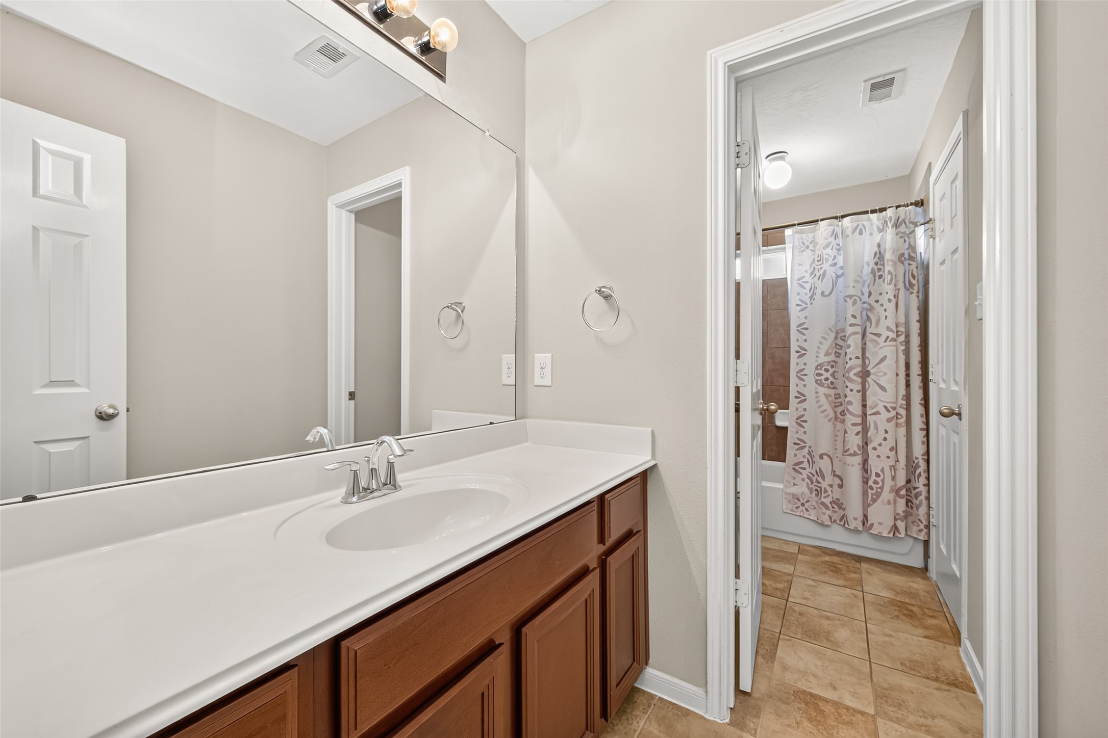 22007 Bridgestone Hawk Court Spring, TX 77388 - Photo 44 of 50 A wide vanity station sits separately from the adjoining bath, creating a convenient arrangement for multiple occupants and keeping personal preparation space distinct.