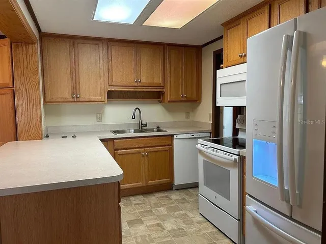 a kitchen with a sink a stove and refrigerator