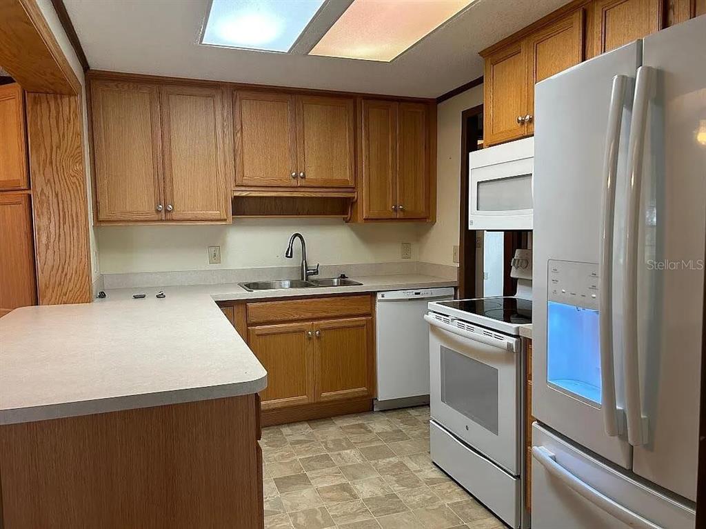 7901 Castile Road Sebring, FL 33876 - Photo 5 of 6 a kitchen with a sink a stove and refrigerator