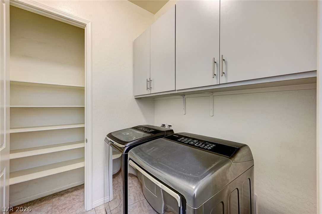 8197 Riley Love Street Las Vegas, NV 89139 - Photo 10 of 48 Functional laundry space featuring a built-in shelf above modern appliances and an adjacent pantry.