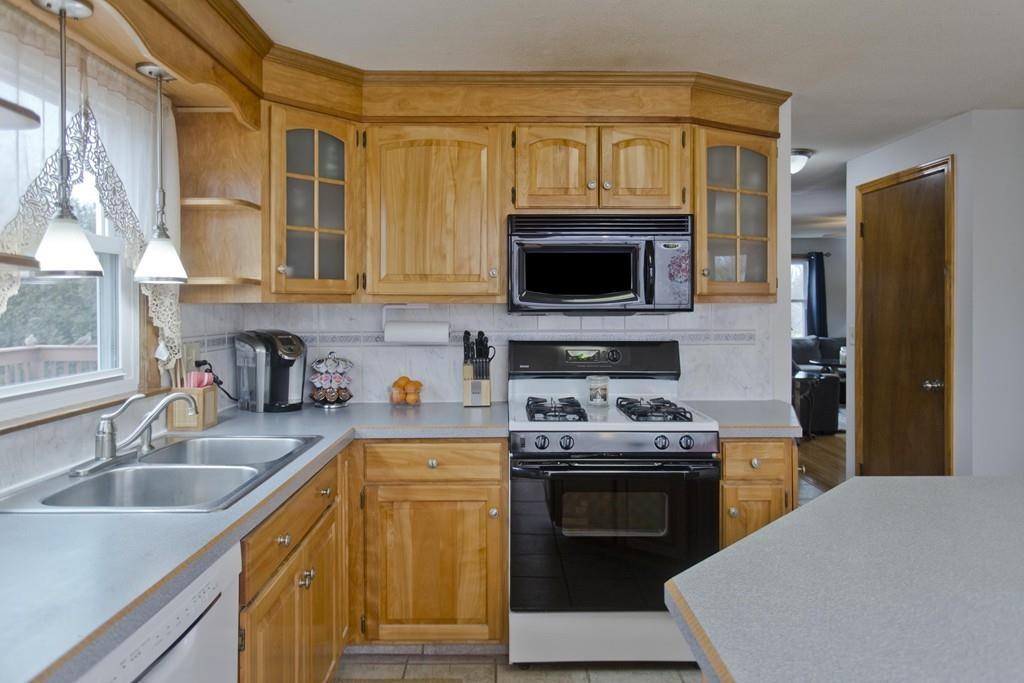 380 Tinkham Road Springfield, MA 01129 - Photo 11 of 42 a kitchen with stainless steel appliances granite countertop a stove a sink and a microwave