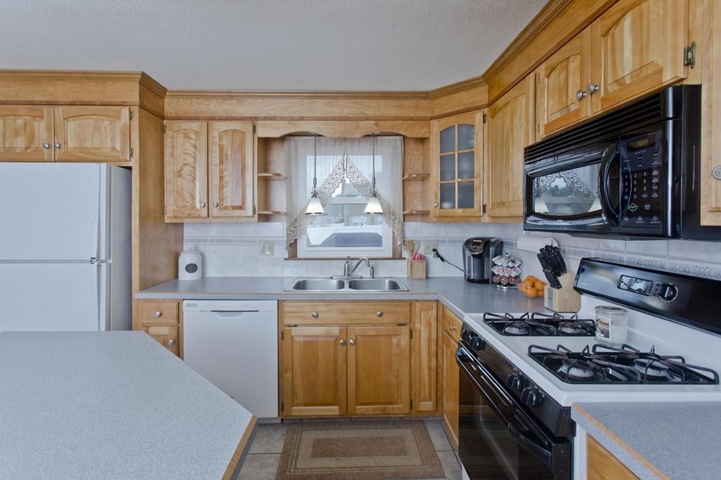 380 Tinkham Road Springfield, MA 01129 - Photo 12 of 42 a kitchen with stainless steel appliances a stove sink microwave and cabinets