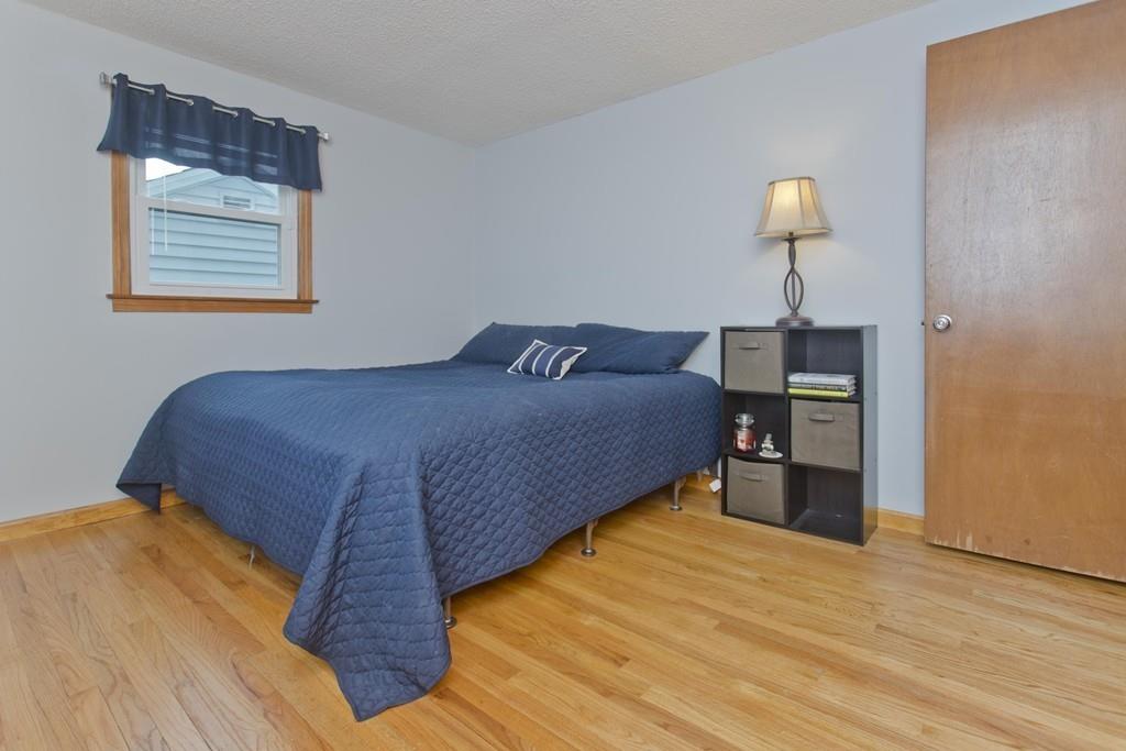 380 Tinkham Road Springfield, MA 01129 - Photo 21 of 42 a bedroom with a bed and a lamp on table