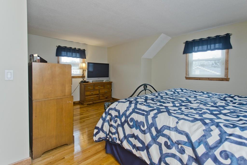 380 Tinkham Road Springfield, MA 01129 - Photo 25 of 42 a bedroom with a bed and wooden floor