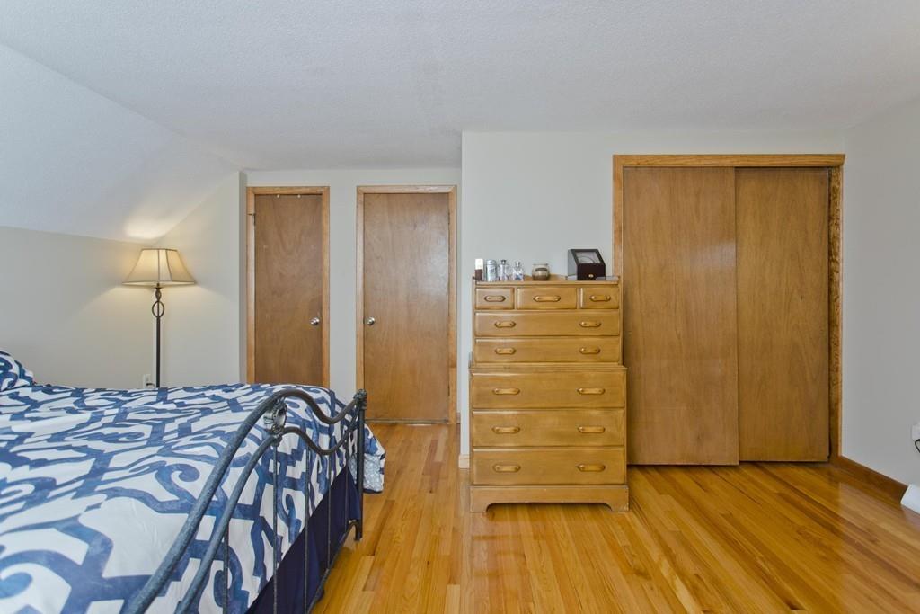 380 Tinkham Road Springfield, MA 01129 - Photo 28 of 42 a bedroom with a bed and wooden floor