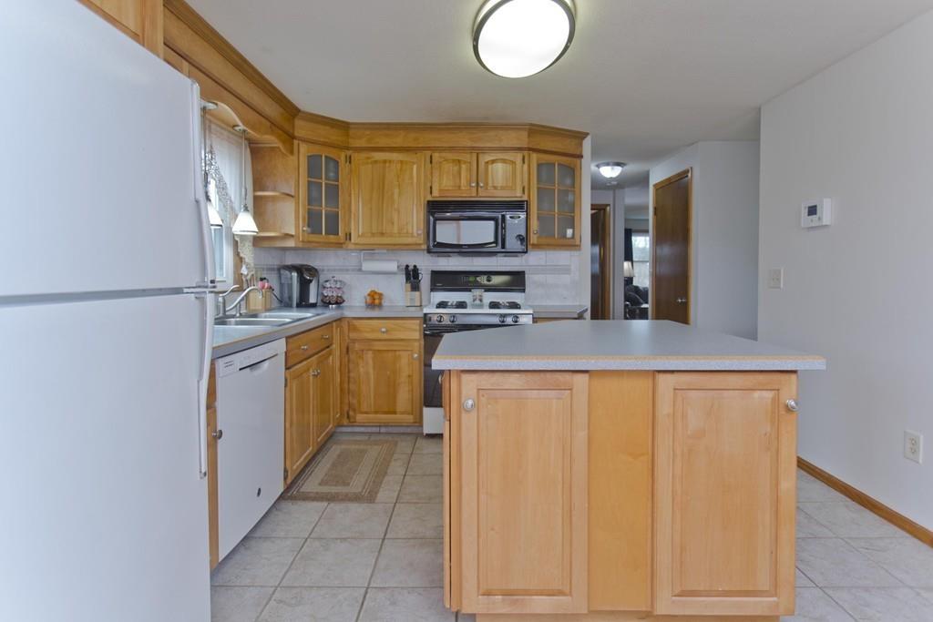 380 Tinkham Road Springfield, MA 01129 - Photo 9 of 42 a kitchen with stainless steel appliances granite countertop a stove a sink and a refrigerator