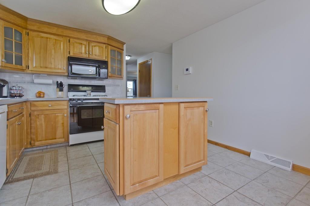 380 Tinkham Road Springfield, MA 01129 - Photo 10 of 42 a kitchen with stainless steel appliances granite countertop a refrigerator and a stove top oven