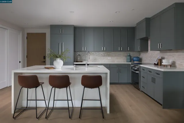 a kitchen with a dining table chairs and sink