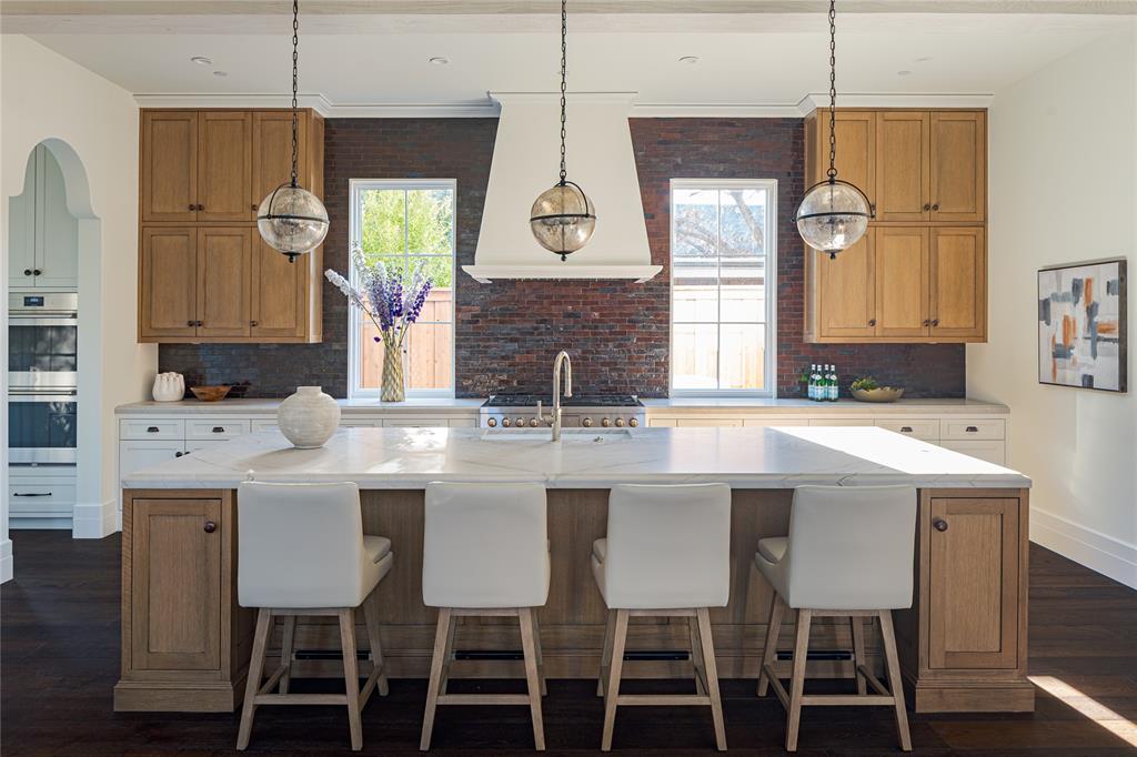 4509 Pomona Road Dallas, TX 75209 - Photo 4 of 17 a kitchen with a dining table chairs cabinets and stainless steel appliances