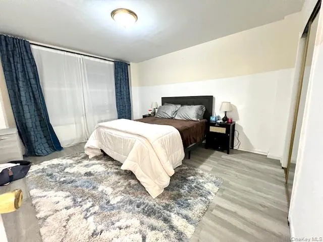 an empty room with wooden floor and closet