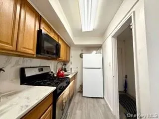 a kitchen with stainless steel appliances granite countertop a stove microwave and sink