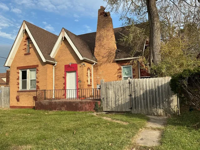 a view of a house with wooden fence