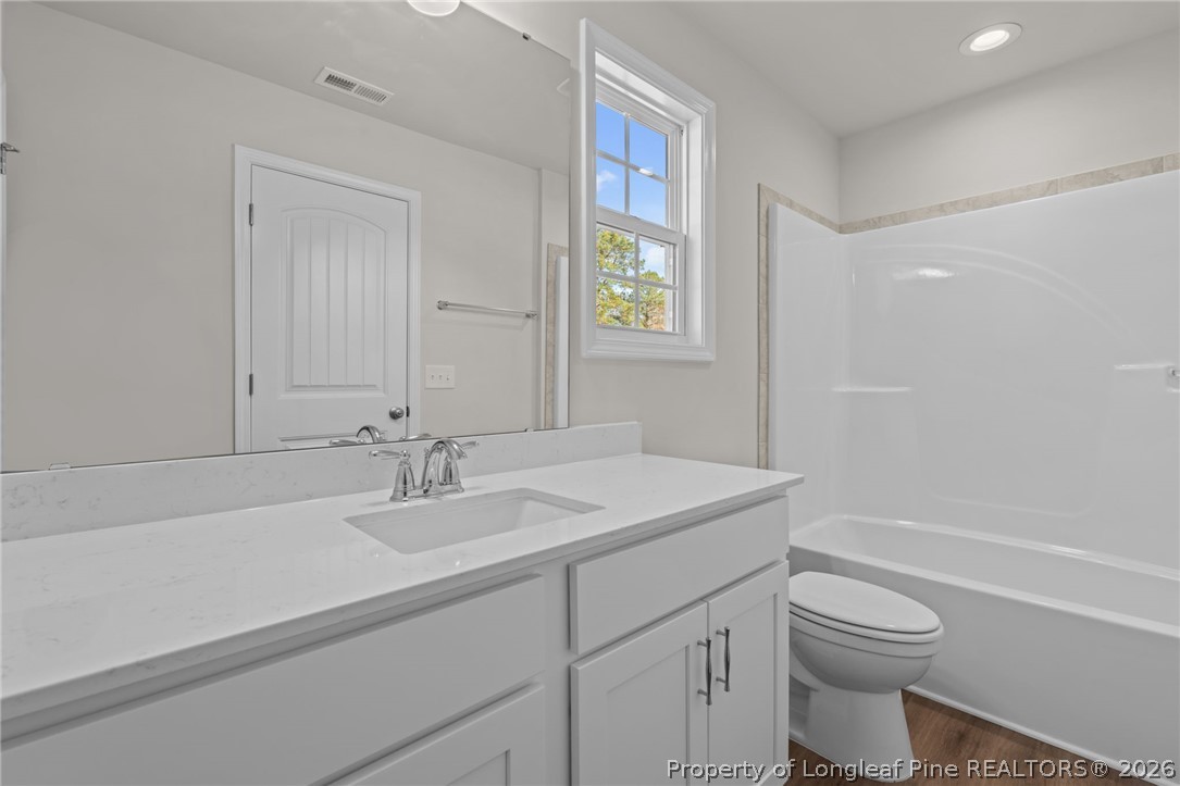 302 Elijah Way Vass, NC 28394 - Photo 15 of 44 a bathroom with a sink a toilet and shower