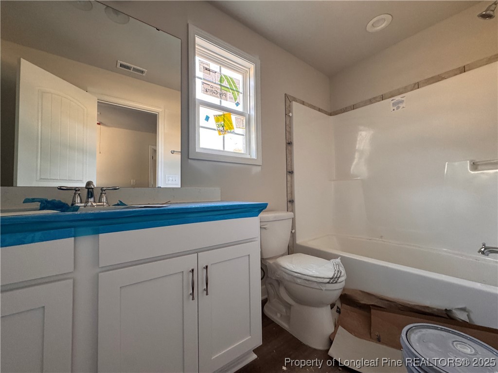 302 Elijah Way Vass, NC 28394 - Photo 20 of 28 a bathroom with a granite countertop toilet sink and mirror