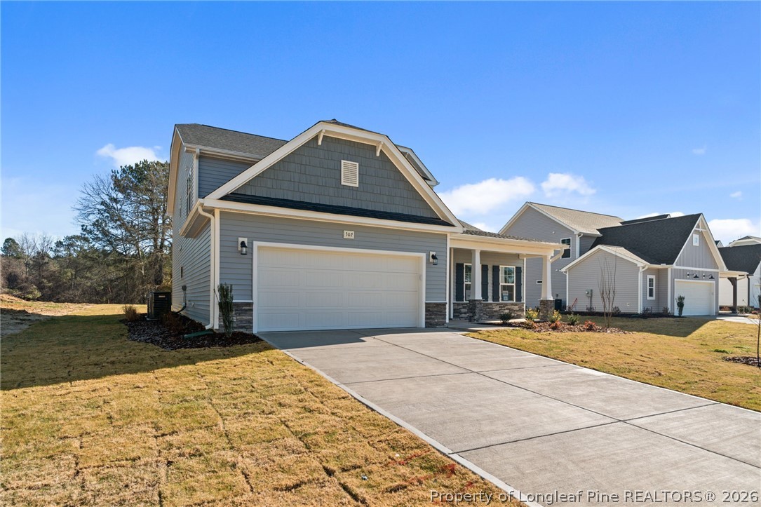 302 Elijah Way Vass, NC 28394 - Photo 2 of 44 a front view of a house with a yard
