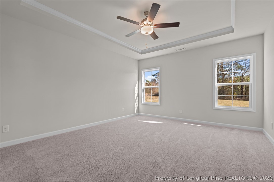 302 Elijah Way Vass, NC 28394 - Photo 21 of 44 an empty room with windows and ceiling fan