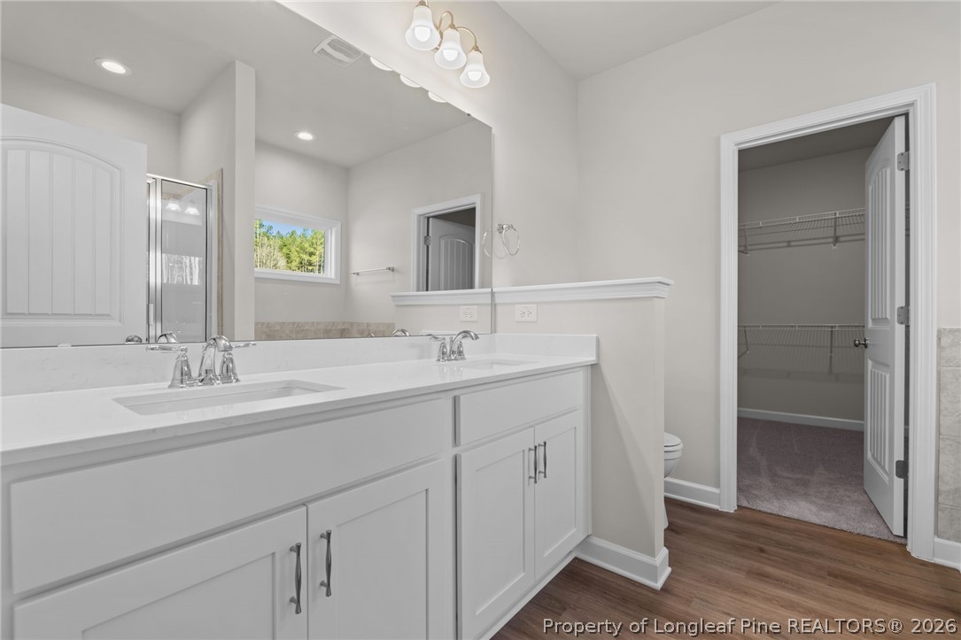 302 Elijah Way Vass, NC 28394 - Photo 23 of 44 a bathroom with double sink and a mirror