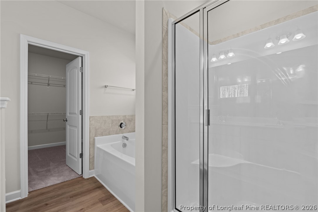 302 Elijah Way Vass, NC 28394 - Photo 24 of 44 a bathroom with a bathtub and a shower