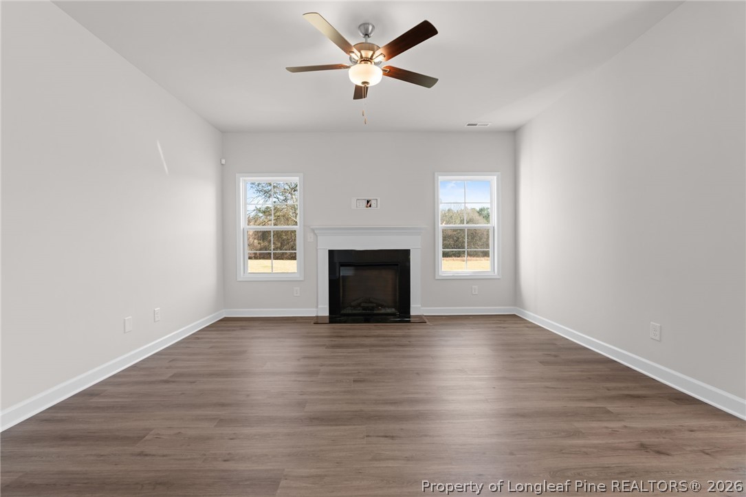 302 Elijah Way Vass, NC 28394 - Photo 27 of 44 a view of empty room with wooden floor and fan