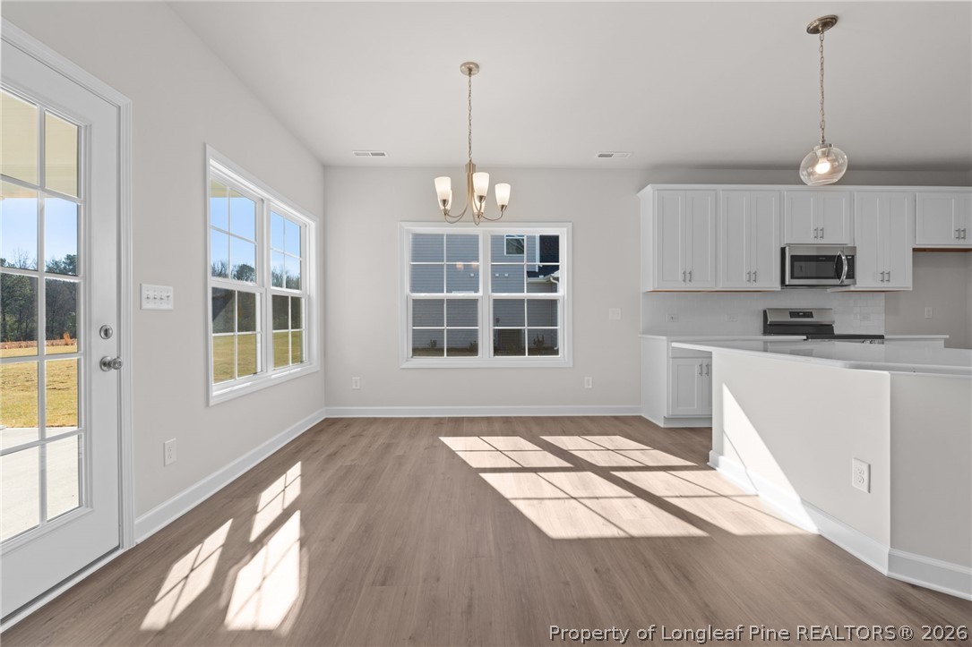 302 Elijah Way Vass, NC 28394 - Photo 31 of 44 a view of a kitchen with kitchen wooden floor and windows
