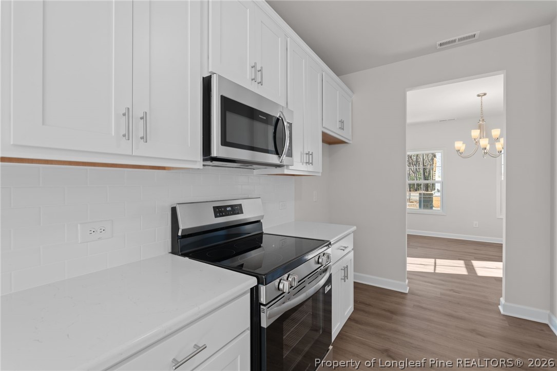 302 Elijah Way Vass, NC 28394 - Photo 32 of 44 a kitchen with a stove and a microwave