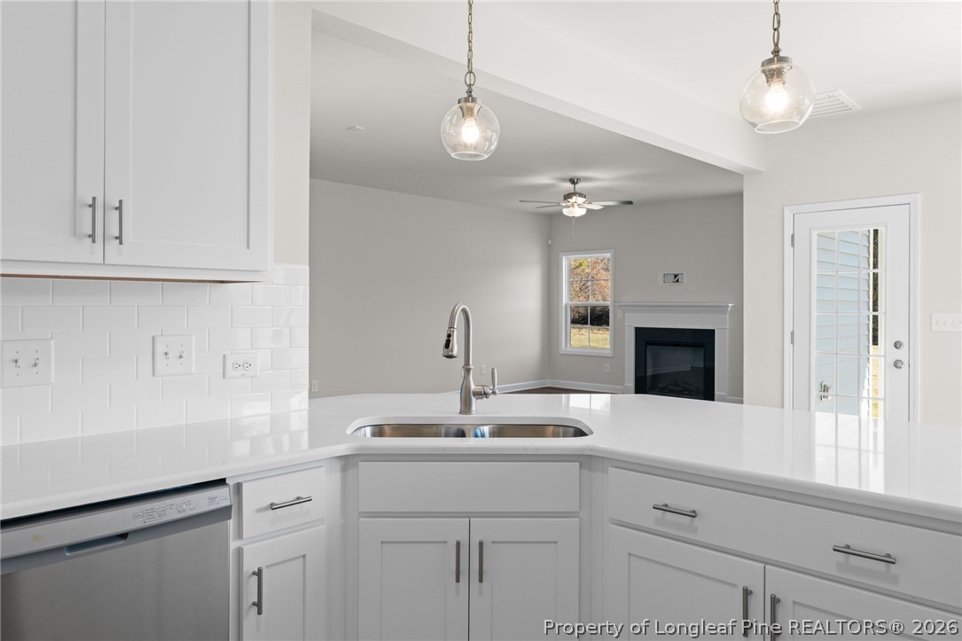 302 Elijah Way Vass, NC 28394 - Photo 33 of 44 a kitchen with a sink and a fireplace